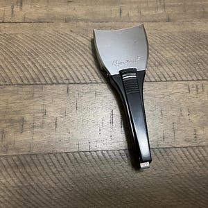 May include: A Remington brand electric shaver head attachment featuring a silver-toned metal foil top and a black plastic handle. The handle includes a textured grip section and a small silver button at the base with the word PRESS printed on it.