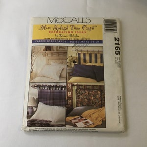 May include: A McCall's sewing pattern for fabric headboards. The pattern is called "More Splash Than Cash" and is designed by Donna Babylon. The pattern number is 2165. The pattern shows three different headboards, each with a different fabric design.