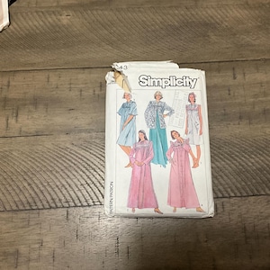 May include: Simplicity sewing pattern #43 for a nightgown. The pattern includes five different styles of nightgowns, with a variety of necklines, sleeves, and lengths. The pattern is printed on white paper with black text and illustrations.
