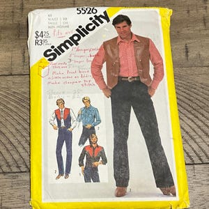 May include: A vintage Simplicity sewing pattern envelope showing a man in a brown waistcoat and black trousers. The envelope is yellow and white with the Simplicity logo and text. The pattern includes instructions for a waistcoat and trousers.