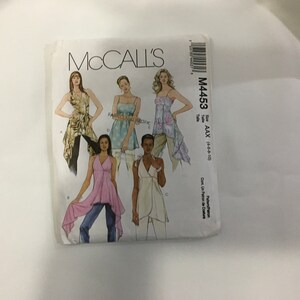 May include: McCall's sewing pattern M4453 for sizes AAX (46-8-10). The pattern includes four different styles of tops with a high-low hemline. The tops are shown on four different models.