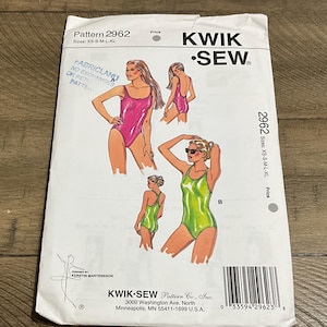 May include: A Kwik Sew pattern envelope, pattern 2962, featuring illustrations of swimsuits. The envelope shows a pink and a green swimsuit design. Sizes available are XS-S-M-L-XL. The envelope is white with black text.