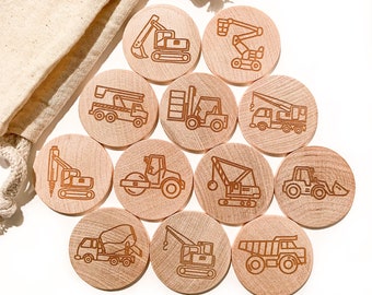 May include: A set of 12 wooden construction vehicle matching game pieces. Each piece features a different construction vehicle, such as a crane, excavator, bulldozer, and dump truck. The pieces are all round and have a natural wood finish.