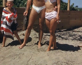 man in speedo on beach