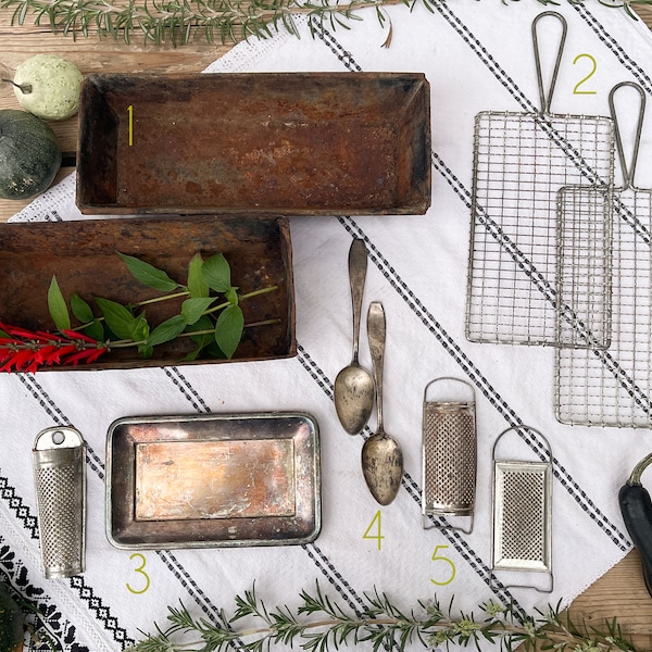 Padelle, grattugie, cucchiaini da tè e pagaia di raffreddamento a filo per la fotografia di alimenti arrugginiti vintage