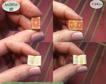 May include: A miniature 1:24 scale book with a red and gold cover featuring ornate detailing. The book is shown in a closed position and an open position, revealing printed pages with intricate illustrations and text on the interior paper.