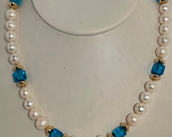 Cultured 10mm pearl and blue topaz and 14k gold filled.  Set includes necklace, bracelet and earrings!