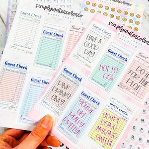 May include: A collection of colorful guest check notepads with various designs and text, including "Have a Good Day" and "Pink Drinks Only." The notepads are in shades of pink, blue, and yellow, with decorative elements.