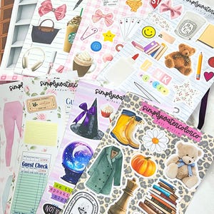 May include: A collection of decorative sticker sheets featuring various designs. The stickers include bows, food items like coffee and ice cream, a teddy bear, a witch hat, a pumpkin, and other assorted illustrations. The sheets have a white background.