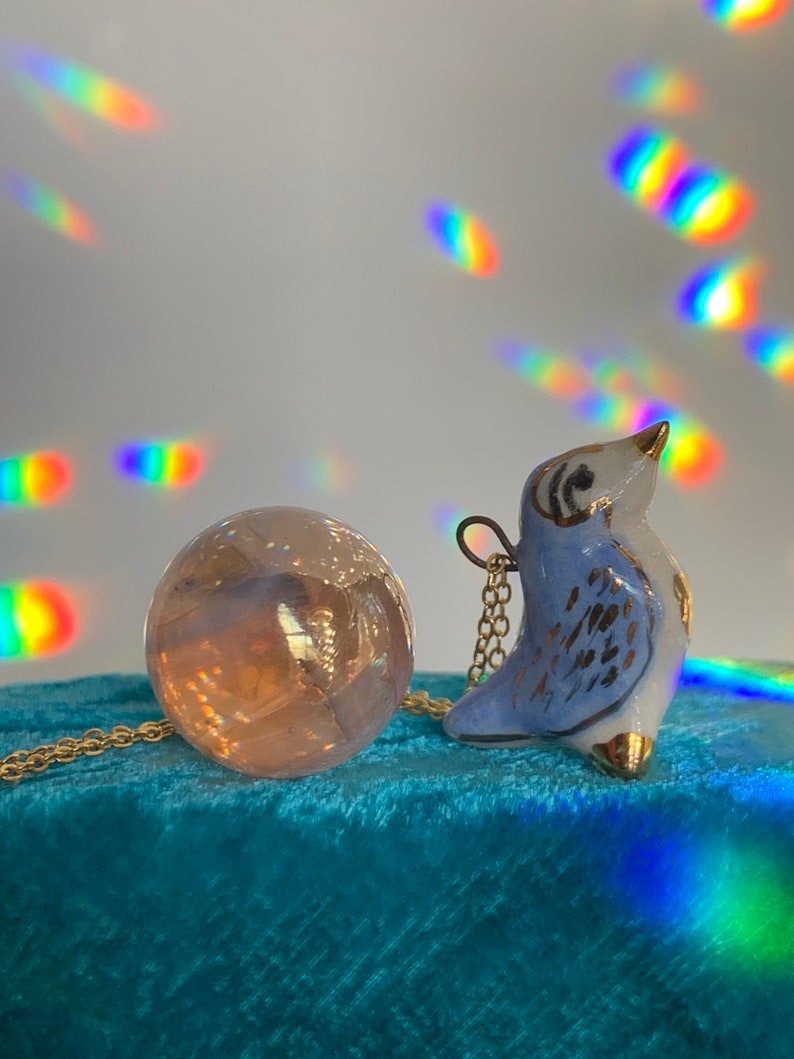 Tiny earthenware blue bird pendant
