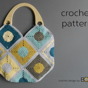 May include: A crochet bag with a wooden handle. The bag is made of squares in shades of blue, yellow, and gray. The squares have a circular pattern in the center. The bag is on a gray background. crochet pattern crochet design by Bori