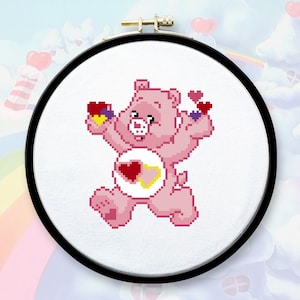 May include: A pink Care Bear with a yellow heart and a red heart on its chest. The bear is holding three hearts in its paws. The bear is smiling and has a pink nose.