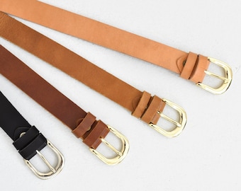 May include: Four leather belts with gold and silver buckles. The belts are in different shades of brown and black.