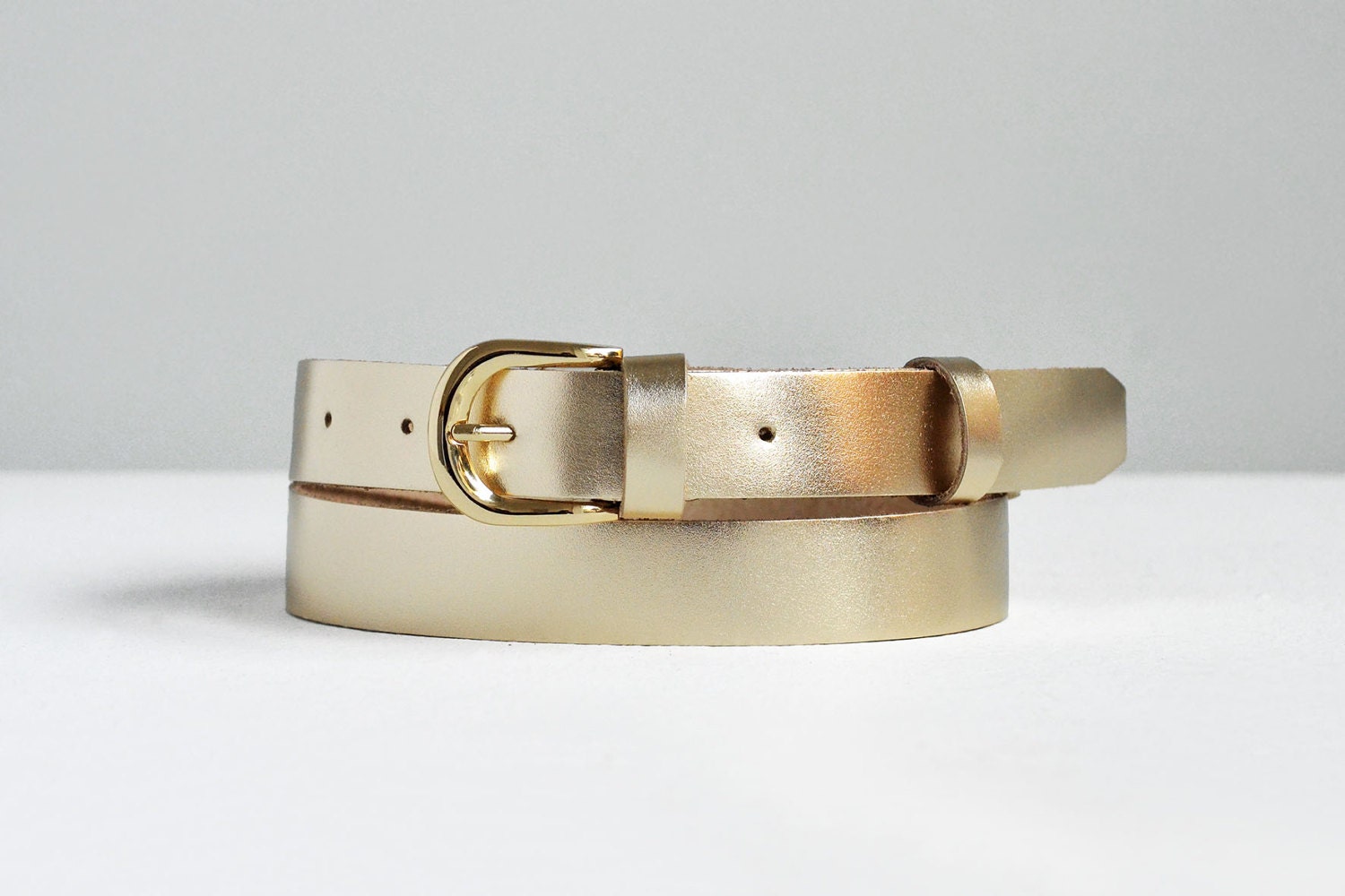 gold-buckle leather belt