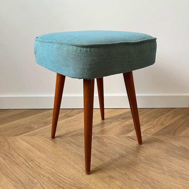 accent stool in turquoise yellow fabric and medium dark wood legs, Poland 1960, vintage mid century modern stool from the 60s, upholstered foot stool in melange turquoise fabric, stunning footrest in modern interior, design furniture for living room