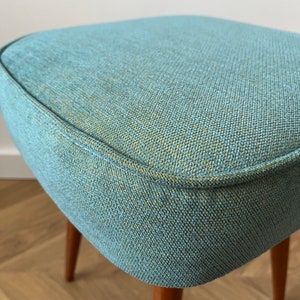 accent stool in turquoise yellow fabric and medium dark wood legs, Poland 1960, vintage mid century modern stool from the 60s, upholstered foot stool in melange turquoise fabric, stunning footrest in modern interior, design furniture for living room