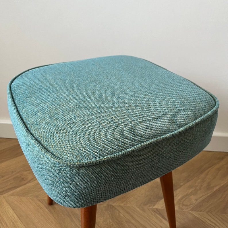 accent stool in turquoise yellow fabric and medium dark wood legs, Poland 1960, vintage mid century modern stool from the 60s, upholstered foot stool in melange turquoise fabric, stunning footrest in modern interior, design furniture for living room