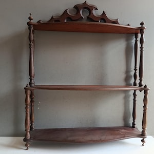 May include: A set of three ceramic nesting bowls in graduating sizes. The bowls feature a speckled, matte finish in shades of cream, light gray, and dark gray. Each bowl has a rounded shape and a slightly flared rim.