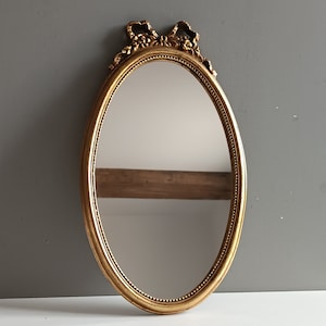 French vintage oval mirror in gilt resin frame with Louis XVI bow / Victorian style decor