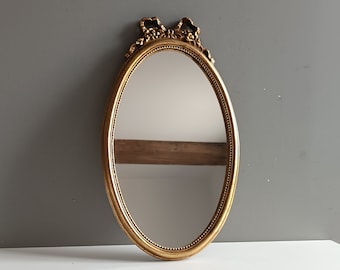 French vintage oval mirror in gilt resin frame with Louis XVI bow / Victorian style decor