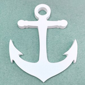 May include: White wooden anchor with a rope loop at the top. The anchor is on a light blue background.