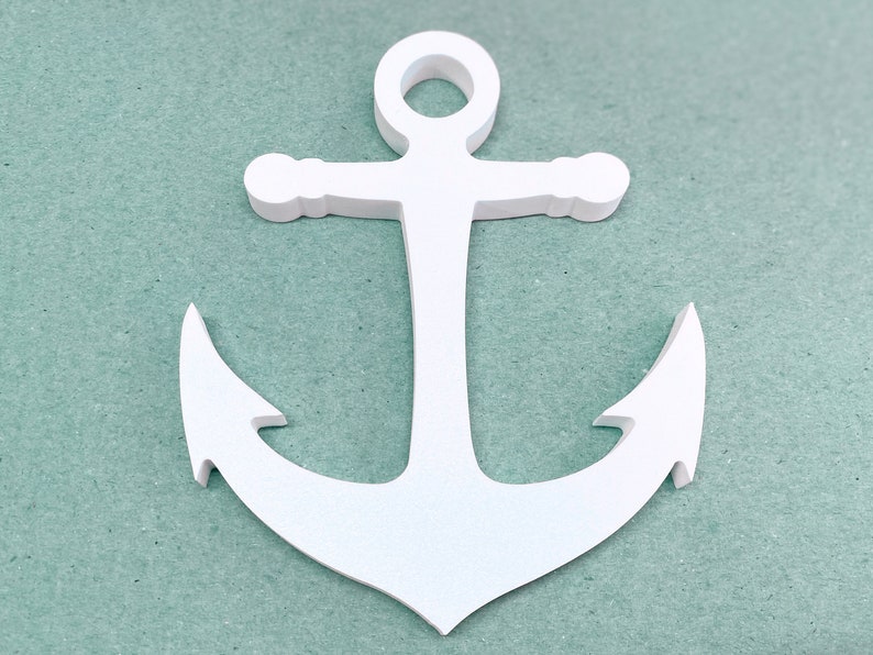 May include: White wooden anchor with a rope loop at the top. The anchor is on a light blue background.