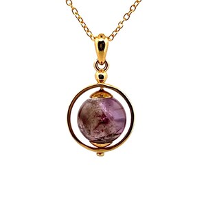 May include: A gold necklace with a pendant featuring a purple amethyst gemstone encased in a spinning gold sphere.