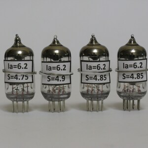 May include: Four silver vacuum tubes with labels that read "la=6.2" and "S=4.75", "la=6.2" and "S=4.9", "la=6.2" and "S=4.85", and "la=6.2" and "S=4.85".