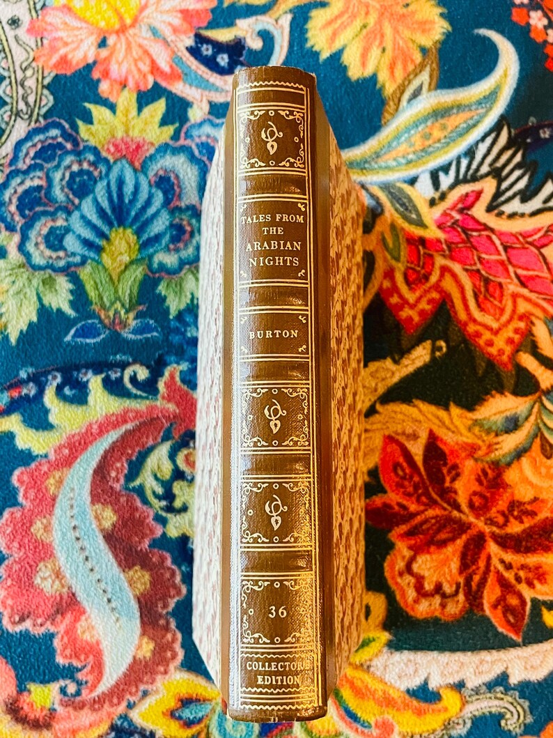 May include: A hardcover book titled "Tales From The Arabian Nights" by Burton. The spine is brown with gold lettering and decorative elements. The book is a collector's edition, with the number 36 visible.