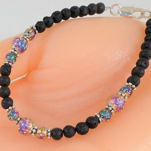 May include: A black lava rock bracelet with iridescent glass beads and a silver clasp.