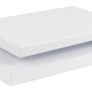 May include: A white rectangular box with a separate lid, slightly ajar. The box and lid are both a bright white color, suggesting a clean and minimalist design. The box is empty, ready for use.