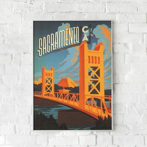 May include: A vintage travel poster featuring a stylised illustration of the Tower Bridge in Sacramento, California. The poster is in a retro style with a blue, orange and yellow colour scheme. The text "Sacramento CA" is displayed at the top of the poster.
