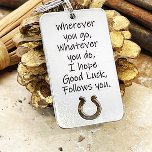 May include: Silver keychain with a horseshoe cutout and the inscription "Wherever you go, Whatever you do, I hope Good Luck, Follows you."
