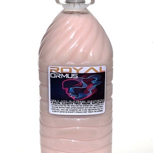 May include: A large, clear plastic bottle filled with a pink liquid. The bottle has a white label with the words "ROYAL ORMUS" and other text. It has a white handle and a gray cap. The label also has a graphic design.