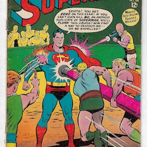 May include: Vintage Superman comic book cover. Superman in a blue suit with a red cape is being attacked by several villains. The cover features the text "SUPERMAN" and "The School for Superman Assassins!"