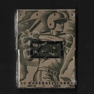 May include: A sealed pack of 10 baseball cards with a metallic gold finish. The front features a stylized illustration of a baseball player swinging a bat, with the text "1994" at the top and "LAIR SERIES 1" and "10 BASEBALL CARDS" printed on the front.