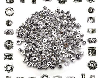 May include: A large assortment of silver metal beads in various shapes and sizes. The beads are perfect for jewellery making, crafting, and DIY projects.