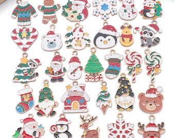 May include: A collection of colorful Christmas-themed charms. The charms include a gingerbread man, Santa Claus, a snowman, a penguin, a bear, a raccoon, a Christmas tree, a snowflake, and a house with the word "Xmas".