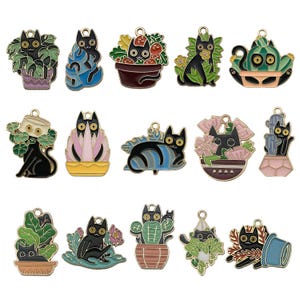 May include: Set of 16 black cat charms with different floral and plant designs. The charms are made of metal and have a gold finish. Each charm features a black cat with different colored flowers, plants, and leaves.