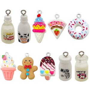May include: A selection of food-themed charms in various colours, including ice cream cones, a donut, a gingerbread man, and milk bottles. The charms are resin with silver loops for attaching to jewellery or crafts.