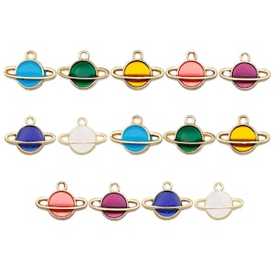 May include: A set of 12 gold-toned metal charms shaped like planets with different colored enamel finishes. The charms are perfect for jewelry making, scrapbooking, and other craft projects.