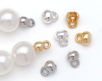 May include: Assortment of silver and gold metal clasps for jewelry making. The clasps are in various shapes and sizes, including round, oval, and teardrop.