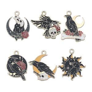 May include: Six gold-tone metal charms featuring black ravens, skulls, and crescent moons. The charms have red and yellow accents and are perfect for jewelry making.
