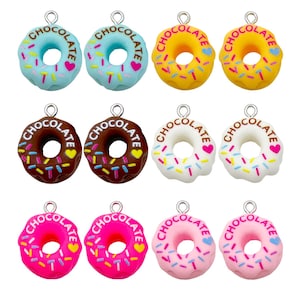 May include: A collection of twelve donut charms in various colors, including blue, yellow, brown, white, pink, and red. Each charm has a silver loop and is decorated with sprinkles, a heart, and the word "CHOCOLATE".