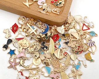 May include: A large assortment of gold-tone metal charms with colorful enamel accents. The charms feature various shapes, including hearts, stars, anchors, and animals. The charms are perfect for jewelry making, scrapbooking, and other craft projects.