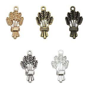May include: Five wheat sheaf charms in different finishes: gold, bronze, silver, antique gold, and antique silver. Each charm features a detailed design of a bundle of wheat stalks tied together with a ribbon.