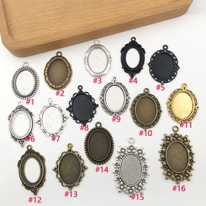 May include: Assortment of 16 silver and bronze oval-shaped pendant trays with different decorative edges. The trays are numbered 1 through 16.