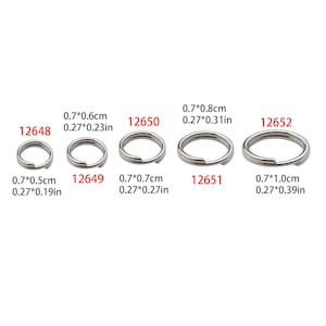 May include: Five silver key rings of different sizes. The rings are labeled with their measurements in inches and centimeters. The ring sizes are 0.7 inches by 0.5 inches, 0.7 inches by 0.6 inches, 0.7 inches by 0.7 inches, 0.7 inches by 0.8 inches, and 0.7 inches by 1.0 inches.