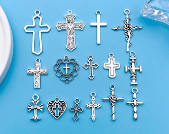 May include: A collection of 15 silver-toned metal cross charms with various designs, including simple crosses, ornate crosses, and crosses with hearts and flowers. These charms are perfect for jewelry making, scrapbooking, and other craft projects.