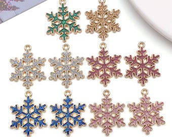 May include: A collection of snowflake charms in various colors, including green, gold, silver, pink, and blue. Each charm has a gold-colored border and a loop for attaching to jewelry or other crafts. These charms are ideal for holiday-themed projects.